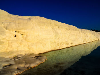 Limestone rock formation by travertine pool at pamukkale