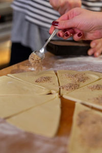Midsection of person preparing food on table