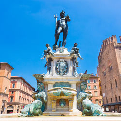 Low angle view of statue against blue sky