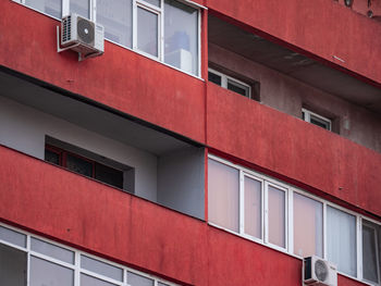 Low angle view of building with ruby red balconies pattern