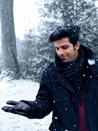 Portrait of young man in snow