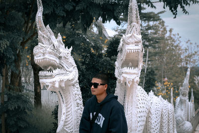 Portrait of a handsome young man standing outdoors