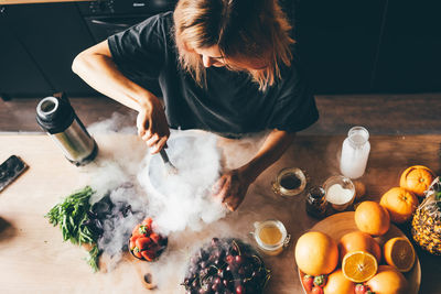 Midsection of woman preparing food on table