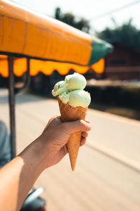 Close-up of hand holding ice cream cone