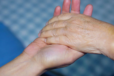 Close-up of hand holding hands