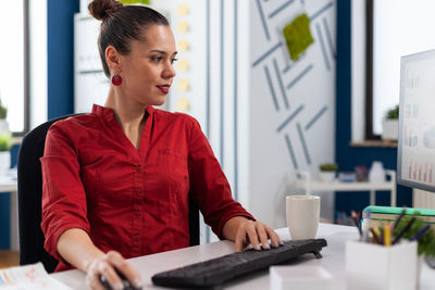 Side view of young man working at office