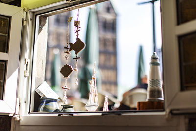 Close-up of electric lamp hanging on window