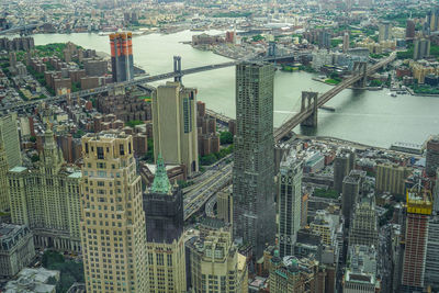 High angle view of modern buildings by river in city