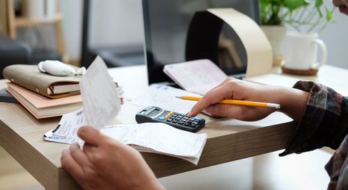 Midsection of woman working on table