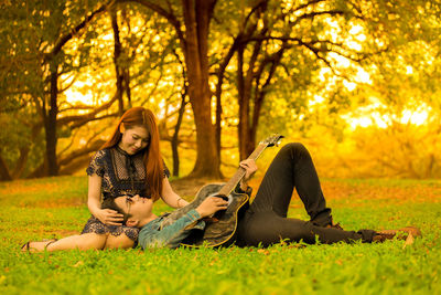 Woman sitting on stone wall