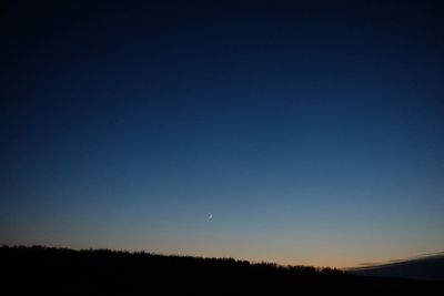 Scenic view of silhouette landscape against clear sky at night