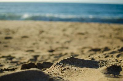 Surface level of sand on beach against sky