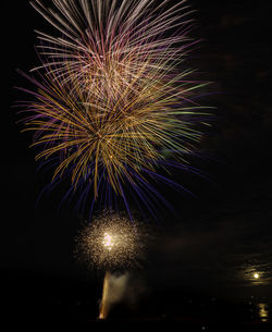 Low angle view of firework display at night