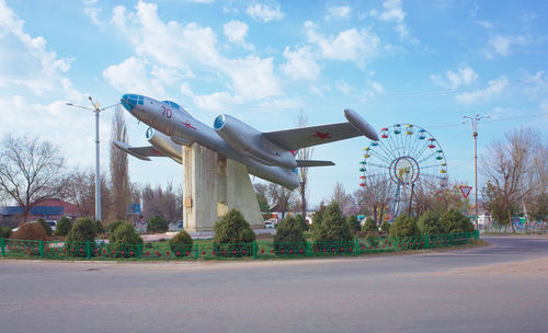 Artificial military airplane at park against sky