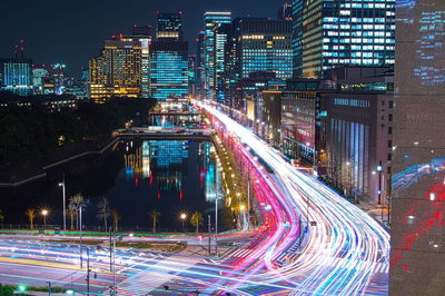 High angle view of illuminated city street and buildings at night