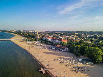 High angle view of buildings and sea against sky