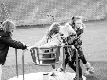 Children playing on merry-go-round at playground