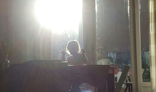 Woman looking through window