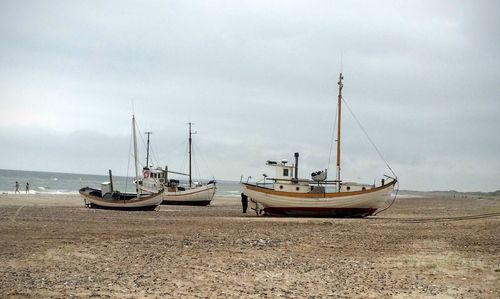 Scenic view of fishing boats on beach