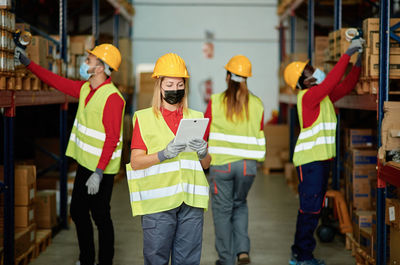 Construction workers taking selfie in warehouse