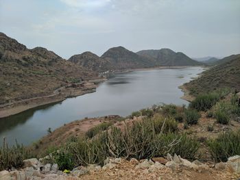 Scenic view of lake and mountains against sky