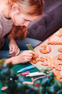 Close-up of girl decorating cookies