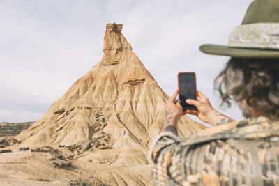 Rear view of woman photographing with camera