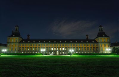 Illuminated building against sky at night