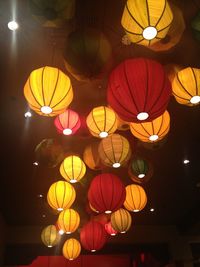 Low angle view of illuminated lanterns hanging at night