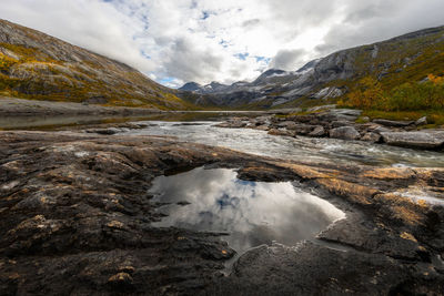 Scenic view of waterfall against sky