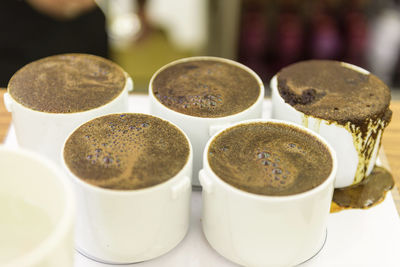 Close-up of coffee and cups on table