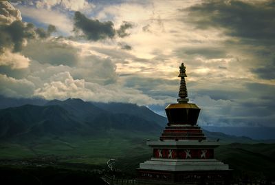 Ancient temple against cloudy sky