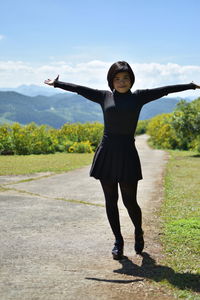 Full length of woman standing against plants