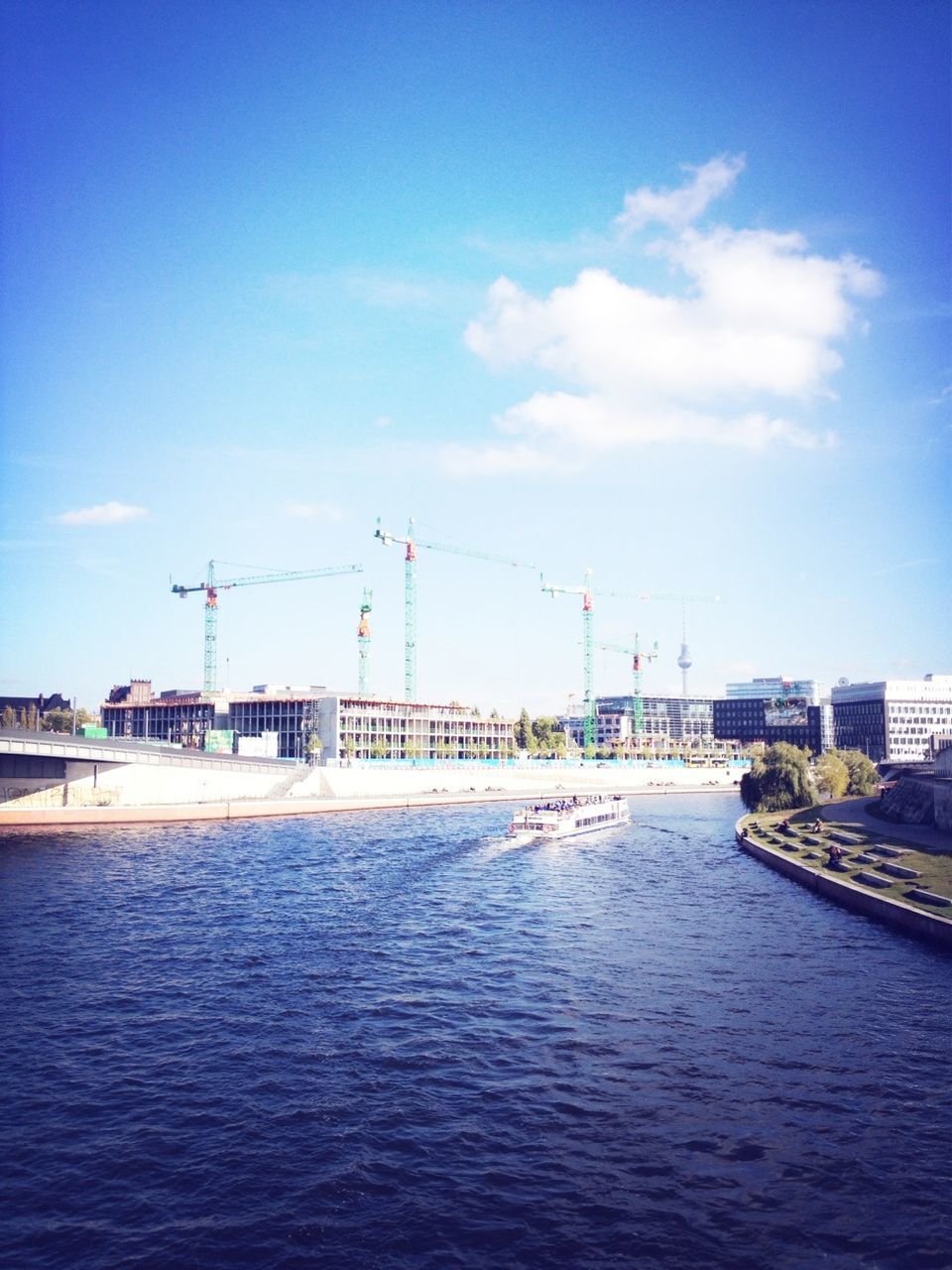 architecture, built structure, water, building exterior, waterfront, blue, sky, transportation, connection, river, city, sea, bridge - man made structure, cloud - sky, day, crane - construction machinery, outdoors, cloud, no people, harbor