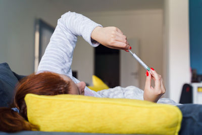 Midsection of couple holding hands at home