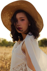 Portrait of beautiful young woman wearing hat