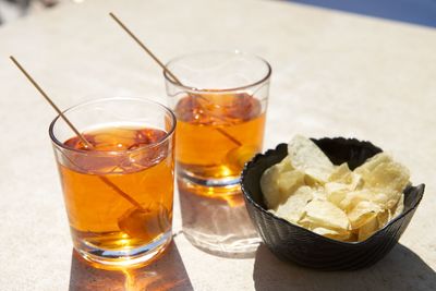 Close-up of drinks with potato chips on table