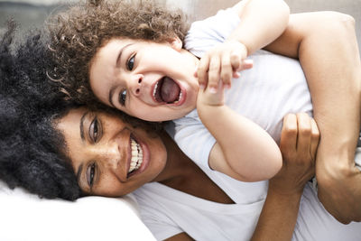 Mother tickling her little son