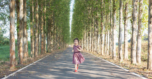 Rear view of woman walking in forest