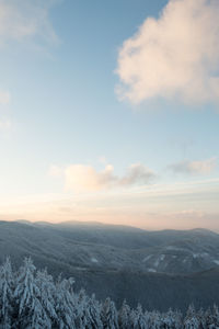 Scenic view of snowcapped mountains against sky during sunset