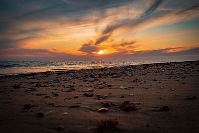 Scenic view of beach against sky during sunset