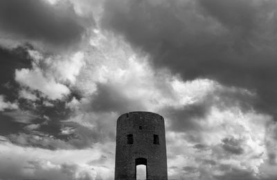 Low angle view of smoke stack against sky