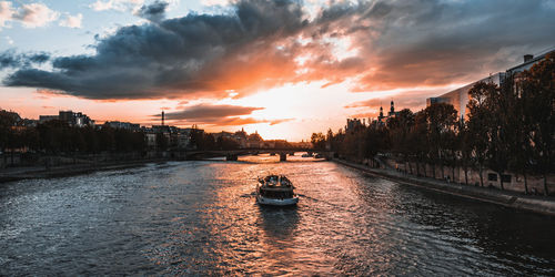 Scenic view of river against sky during sunset