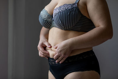 Midsection of woman standing at home