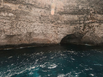 Scenic view of sea seen through cave