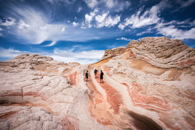 Rock formations on mountain against cloudy sky