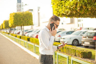 Man using mobile phone in city