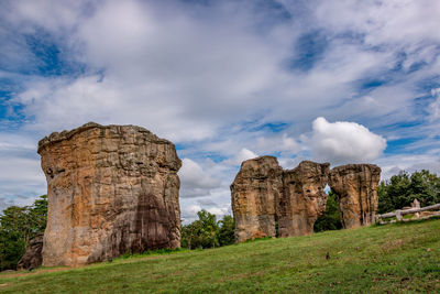 View of castle on field against cloudy sky