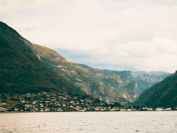 Scenic view of river and mountains against sky