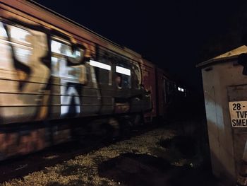 Train on railroad track against sky at night